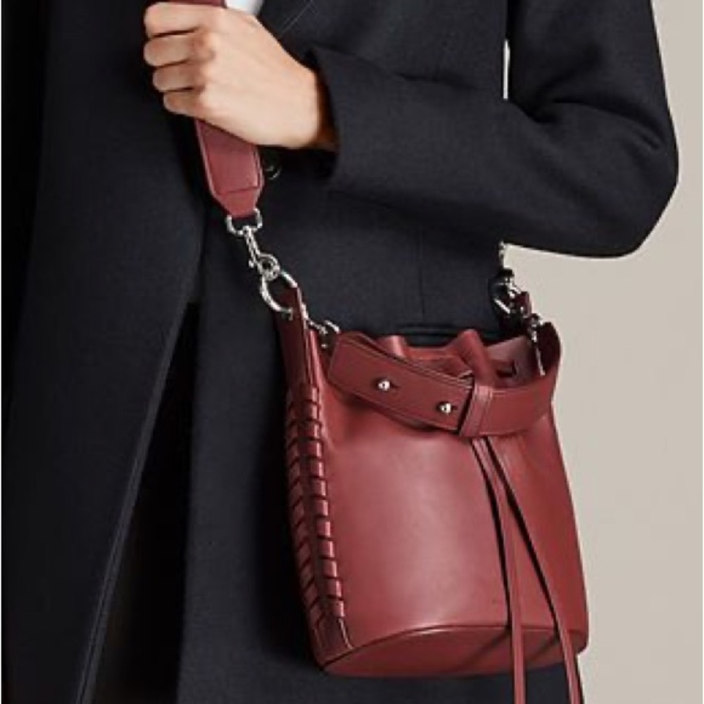 All Saints Ray small bucket bag in berry red